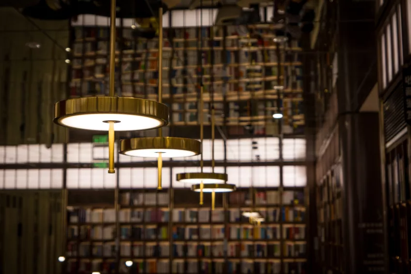 Golden lamps in a library. Photo.